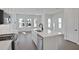 Modern kitchen with stainless steel appliances, large kitchen island, and an abundance of natural light at 9019 Rothman Ln, Lakewood Ranch, FL 34240