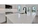 Modern kitchen with stainless steel appliances, a large island, and lots of natural light at 9019 Rothman Ln, Lakewood Ranch, FL 34240