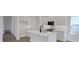 Modern kitchen featuring white cabinets, stainless steel appliances, and an island with sink at 9019 Rothman Ln, Lakewood Ranch, FL 34240