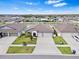 Aerial view of the house showcases a manicured lawn and three-car garage at 13557 Willow Bluestar Loop, Riverview, FL 33579