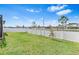 This backyard features a white fence and a green lawn at 13557 Willow Bluestar Loop, Riverview, FL 33579