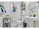 This half bathroom features decor shelving, a toilet, and sink at 13557 Willow Bluestar Loop, Riverview, FL 33579