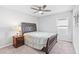 Bedroom featuring a comfortable bed, neutral carpet, and a ceiling fan at 13557 Willow Bluestar Loop, Riverview, FL 33579