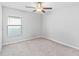 This bedroom features carpet flooring, ceiling fan and a window at 13557 Willow Bluestar Loop, Riverview, FL 33579