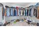Walk-in closet with ample storage and organizational space for clothing and shoes at 13557 Willow Bluestar Loop, Riverview, FL 33579