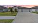Charming single-story home featuring a two-car garage and manicured lawn at 13557 Willow Bluestar Loop, Riverview, FL 33579
