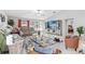 Bright living room includes tile flooring, modern furniture, and sliding glass doors to outdoor space at 13557 Willow Bluestar Loop, Riverview, FL 33579