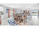 Open-concept living and dining area features tile floors, dining table, and comfortable seating at 13557 Willow Bluestar Loop, Riverview, FL 33579