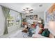 Cozy living room with large windows, ceiling fan, and stylish decor at 13557 Willow Bluestar Loop, Riverview, FL 33579