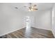 Spacious bedroom featuring new laminate flooring, ceiling fan and an open doorway at 1652 Open Field Loop, Brandon, FL 33510