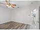 Bright bedroom with stylish wood flooring and ceiling fan, showcasing a clean and inviting space at 1652 Open Field Loop, Brandon, FL 33510