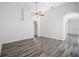 Open living room with wood floors, ceiling fan, and an archway leading to other rooms at 1652 Open Field Loop, Brandon, FL 33510