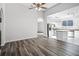 Spacious living room open to the kitchen with new wood flooring and recessed lighting at 1652 Open Field Loop, Brandon, FL 33510