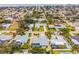 Aerial view of a home with a yard featuring tropical landscaping and a screened-in pool at 909 Dawn St, Venice, FL 34285