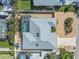 Aerial view of the property featuring screened pool, landscaped yard, and well-maintained roof at 909 Dawn St, Venice, FL 34285