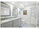 Bathroom featuring dual sinks, granite countertops, modern fixtures, and walk-in shower at 909 Dawn St, Venice, FL 34285
