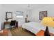Cozy bedroom with natural light features desk, rug, and comfortable bed at 909 Dawn St, Venice, FL 34285