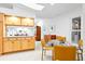 Eat-in kitchen area with a glass-topped dining table set, wood cabinets, and neutral color palette at 909 Dawn St, Venice, FL 34285