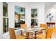 Cozy dining area offers bright windows and a glass-topped table set overlooking the kitchen at 909 Dawn St, Venice, FL 34285