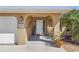 Covered front entryway with an arched doorway and stone accents next to the home's two-car garage at 909 Dawn St, Venice, FL 34285