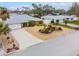 Charming home with meticulously landscaped front yard, enhanced by decorative rock and palm trees at 909 Dawn St, Venice, FL 34285