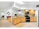 Modern kitchen with stainless steel appliances, granite countertops, and an open layout at 909 Dawn St, Venice, FL 34285