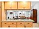 Stylish kitchen featuring granite countertops and wooden cabinetry that offers ample storage space at 909 Dawn St, Venice, FL 34285