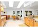 Bright kitchen featuring granite countertops, stainless steel sink, and natural light from skylights and windows at 909 Dawn St, Venice, FL 34285
