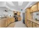 Bright kitchen featuring granite countertops, light wood cabinets, and stainless steel appliances at 909 Dawn St, Venice, FL 34285