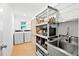 Convenient laundry room with a stainless steel sink and ample shelving for storage at 909 Dawn St, Venice, FL 34285