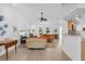 Bright living room with vaulted ceiling, wood floors, and an open layout to the breakfast bar at 909 Dawn St, Venice, FL 34285