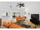 Bright and airy living room featuring wood floors and sliding glass doors leading to the pool at 909 Dawn St, Venice, FL 34285