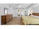 Bright main bedroom with hardwood floors, ample closet space, and access to the outdoors at 909 Dawn St, Venice, FL 34285