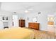 Inviting main bedroom with hardwood floors, ceiling fan, and view of the bathroom at 909 Dawn St, Venice, FL 34285