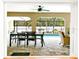 Patio with outdoor dining and living areas overlooks the pool at 909 Dawn St, Venice, FL 34285