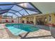 Backyard oasis boasts a sparkling pool, screened-in patio, and ample lounge areas at 909 Dawn St, Venice, FL 34285