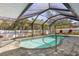 Inviting private pool with screened enclosure, surrounded by lush landscaping at 909 Dawn St, Venice, FL 34285