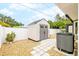 Backyard storage shed featuring white and grey paint and a gravel foundation at 909 Dawn St, Venice, FL 34285