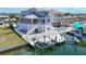 A beautiful outdoor waterfront space including an outdoor bar, swimming pool, and boat lift at 13737 Victor Ave, Hudson, FL 34667
