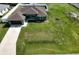 Aerial view of a well-maintained home featuring a spacious yard and an attached two-car garage at 4154 Duluth Ter, North Port, FL 34286