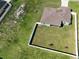 Aerial view of a home with a fenced-in backyard, lush green grass, and a brown shingle roof at 4154 Duluth Ter, North Port, FL 34286