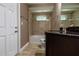 Bathroom featuring a tiled shower/tub combo, a single sink dark vanity, and tile floors at 4154 Duluth Ter, North Port, FL 34286
