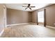A comfortable bedroom with wood-look floors, a ceiling fan, and window at 4154 Duluth Ter, North Port, FL 34286