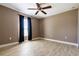 Bedroom with ceiling fan, light tile flooring, a window with blackout curtains at 4154 Duluth Ter, North Port, FL 34286