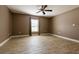 A cozy bedroom with wood-look floors, ceiling fan, and natural lighting at 4154 Duluth Ter, North Port, FL 34286