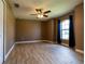 Comfortable bedroom with wood-look tile, fan, neutral paint, and natural light at 4154 Duluth Ter, North Port, FL 34286