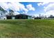 Well-manicured home exterior with a lush green lawn and a view of the surrounding neighborhood at 4154 Duluth Ter, North Port, FL 34286