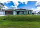 Charming single-story home featuring a well-manicured lawn, two-car garage, and neutral color palette at 4154 Duluth Ter, North Port, FL 34286