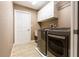 Laundry room features updated washer and dryer, tile flooring, and door to outside at 4154 Duluth Ter, North Port, FL 34286