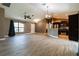 Open-concept living area and kitchen featuring stainless steel appliances and wood-look flooring at 4154 Duluth Ter, North Port, FL 34286